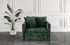 Green velvet armchair sofa bed with cushions in a room with white paneled walls and a plant.