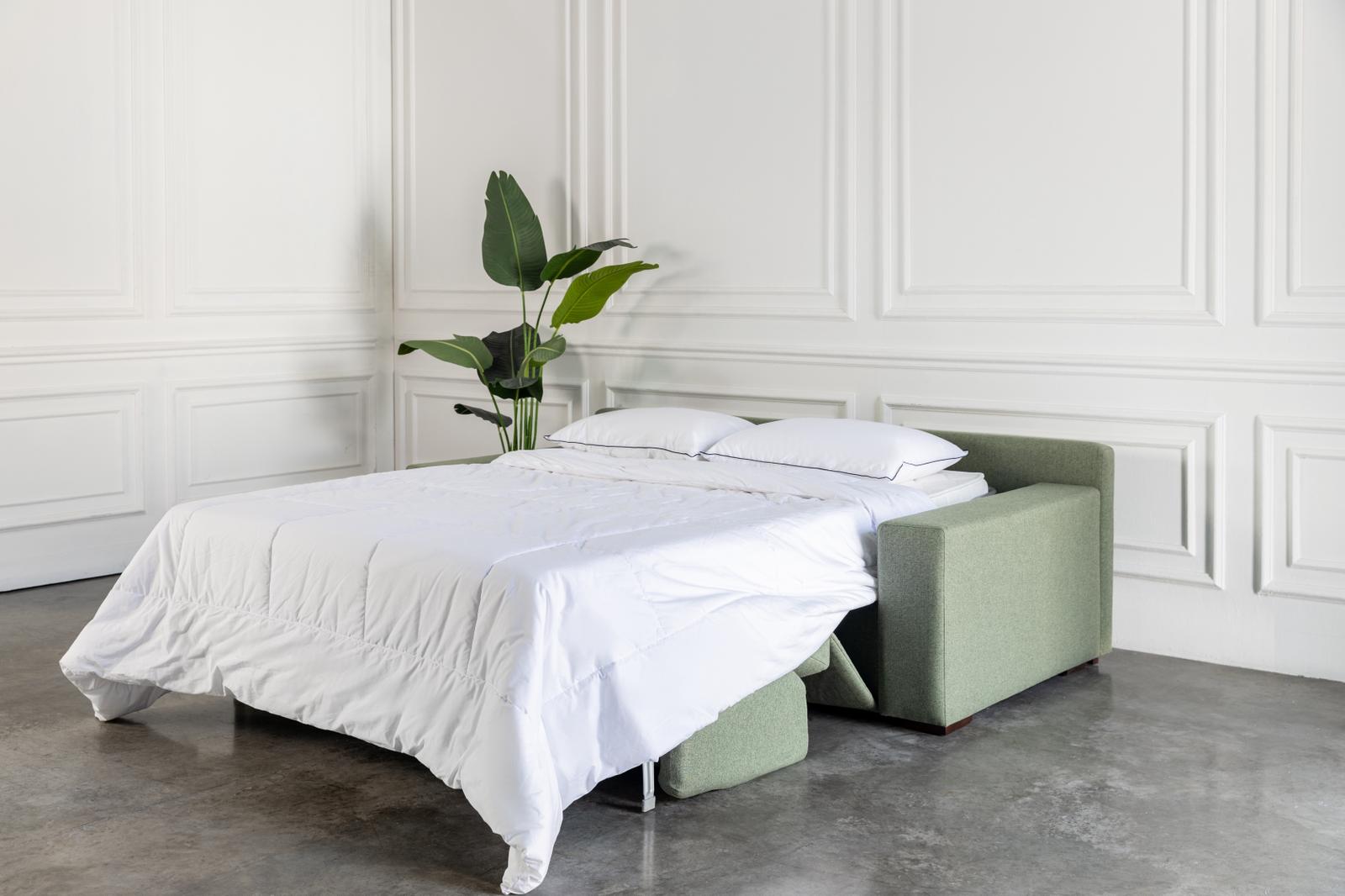 comeover sofa bed with hospitality grade white bedding and green frame